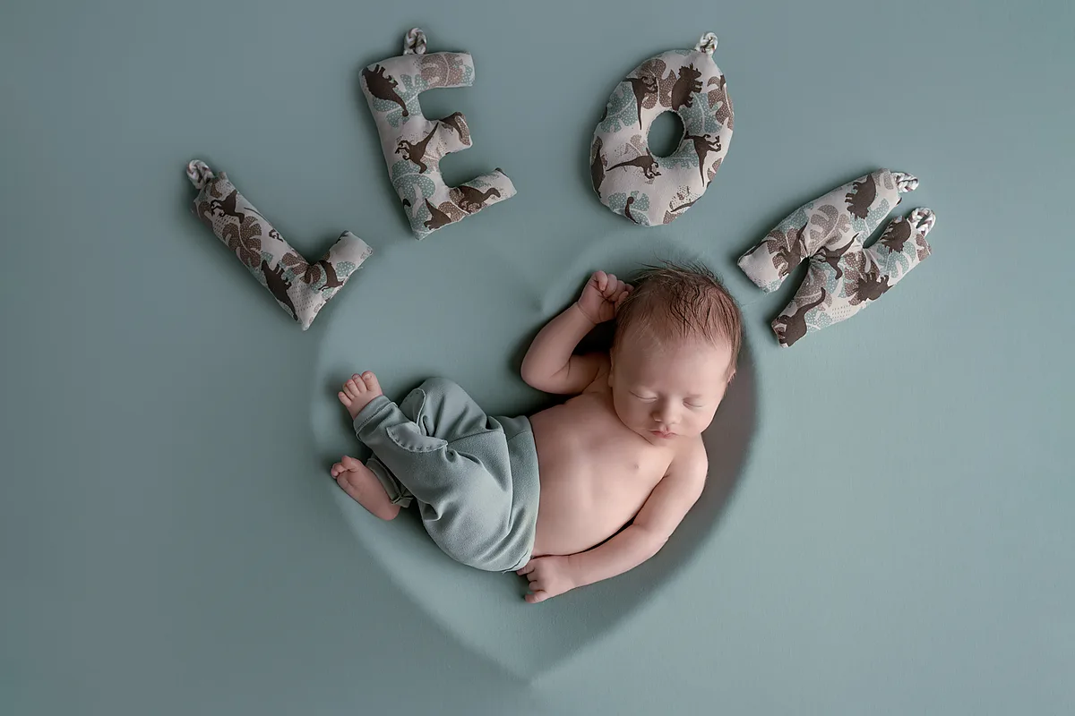 Neugeborenes im Nest aus Federn – zarte Newborn-Aufnahme
